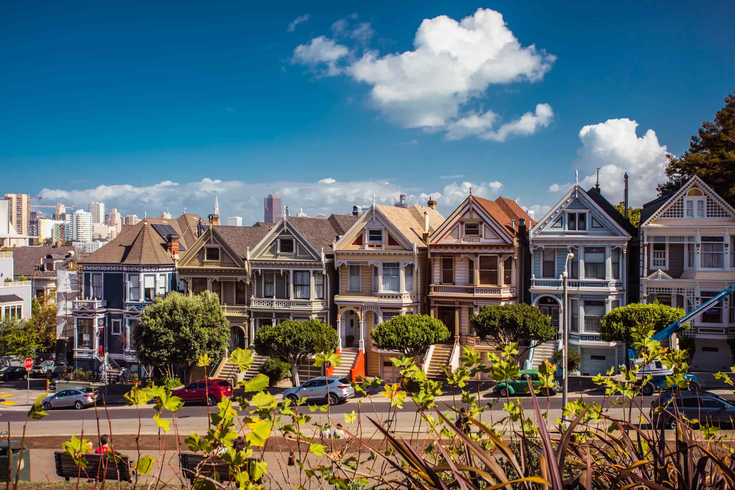 a row of victorian houses known as the painted ladies in front of the san francisco skyline