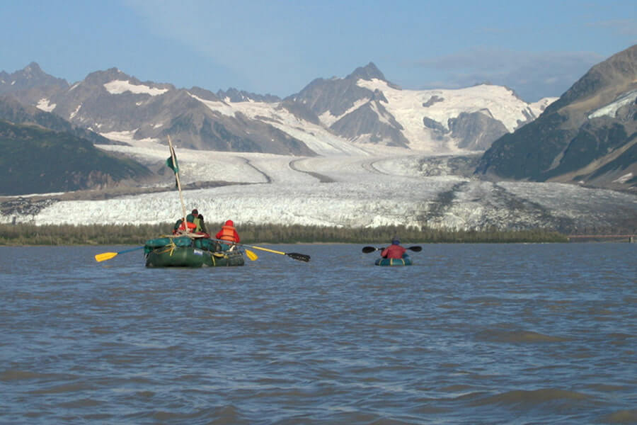 kayakers float down the copper river toward a glacier