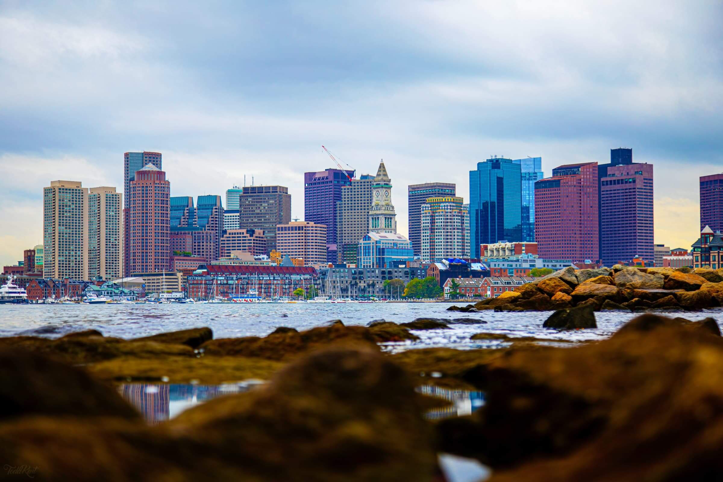 a view of the boston skyline next to the water