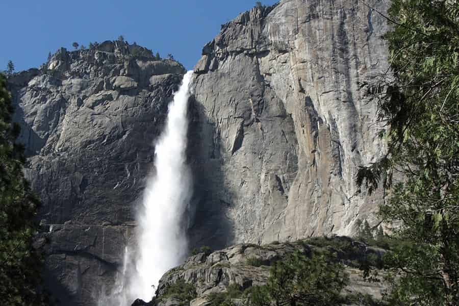 a view up at the cascading yosemite falls from its cliff height