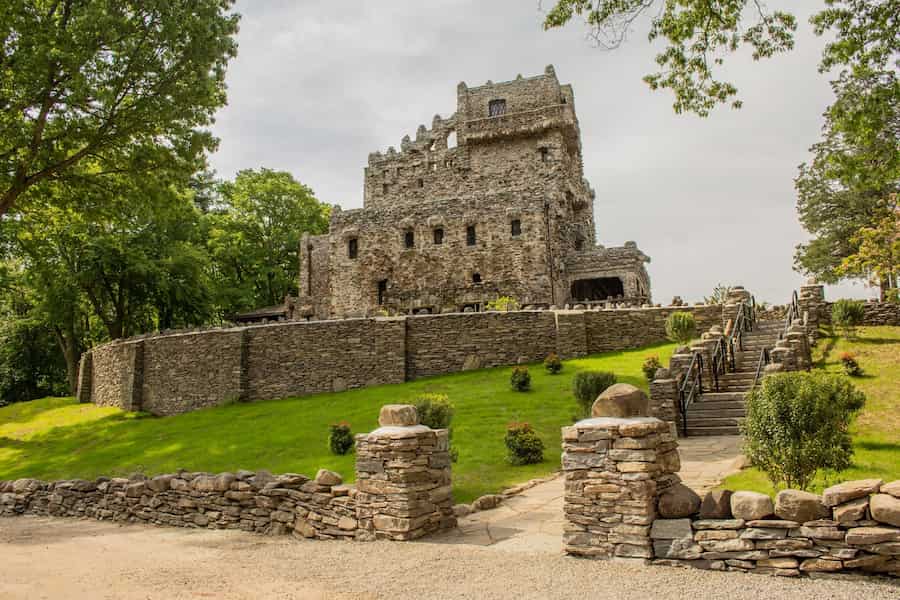 an exterior view of gillette castle sitting on a hill