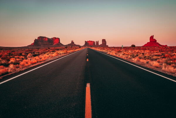 an empty road heading toward the arizona horizon