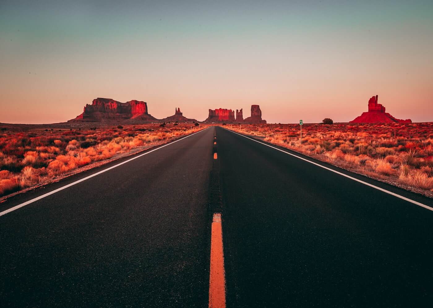an empty road heading toward the arizona horizon