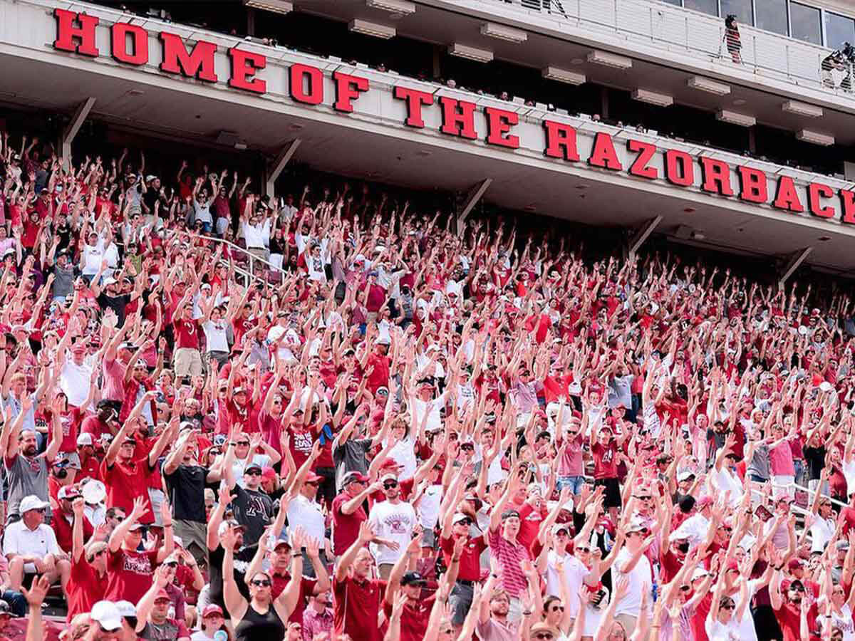 fans calling the hogs at a razorback game in northwest arkansas