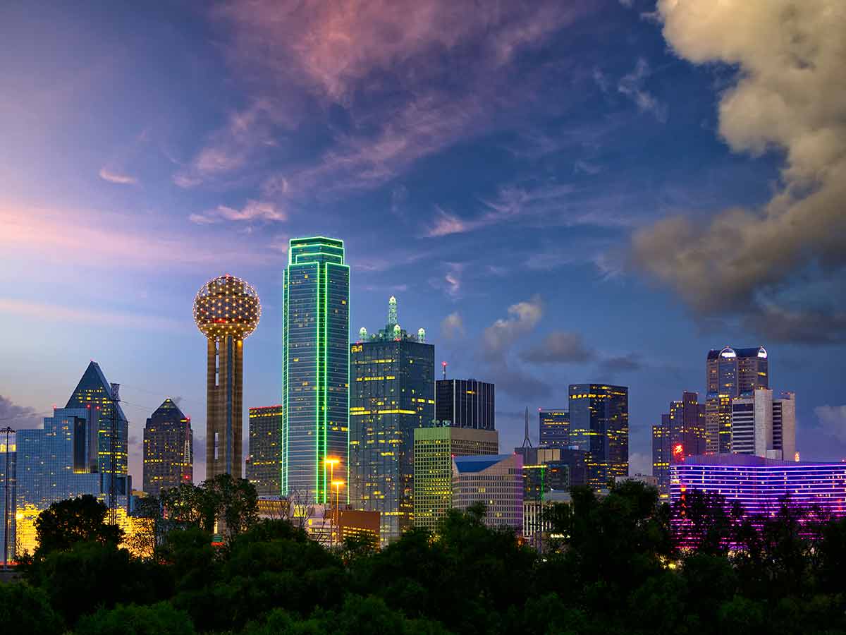 a view of the skyline of dallas at night with the buildings lit up