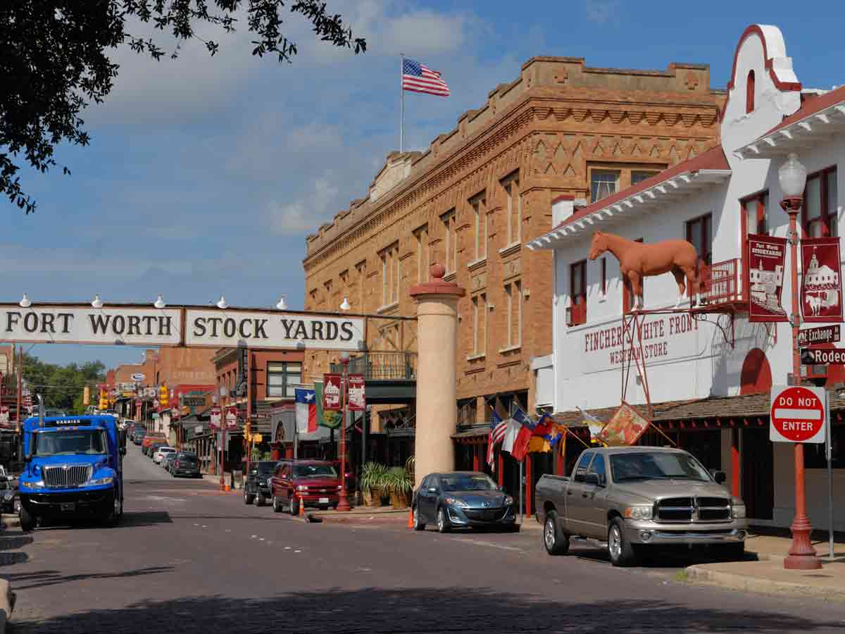a view down exchange avenue with a sign denoting the fort worth stockyards historic district