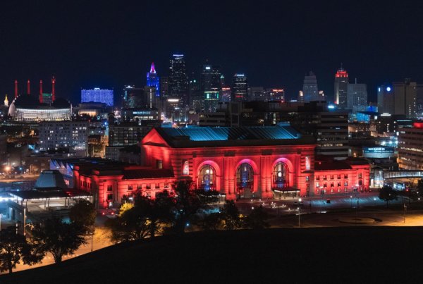 union station in kansas city lit up in red lights at night