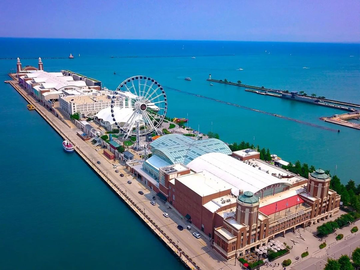 an aerial view of navy pier in chicago jutting out into lake michigan