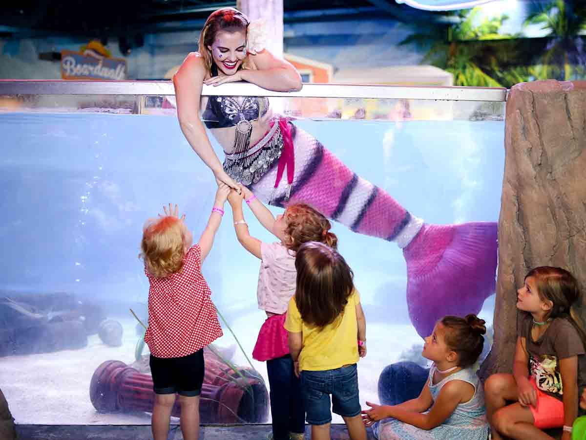 a mermaid plays with children at seaquest fort worth