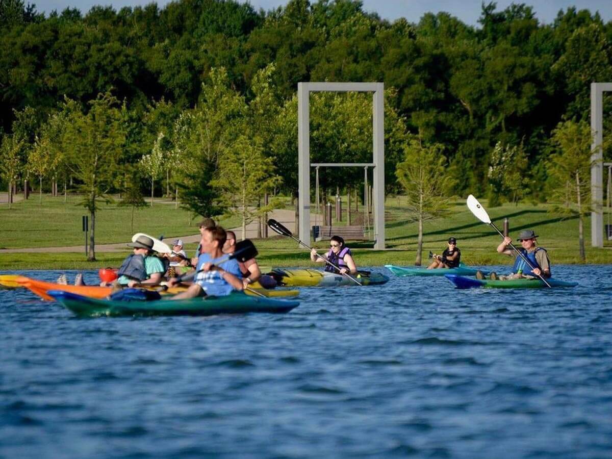 a lake with canoes at shelby farms park
