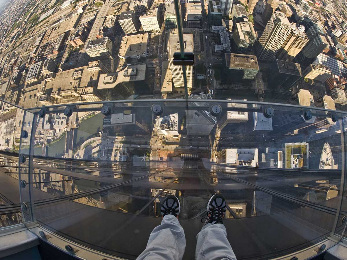 a view from the willis tower observation deck looking down toward the ground through a glass floor
