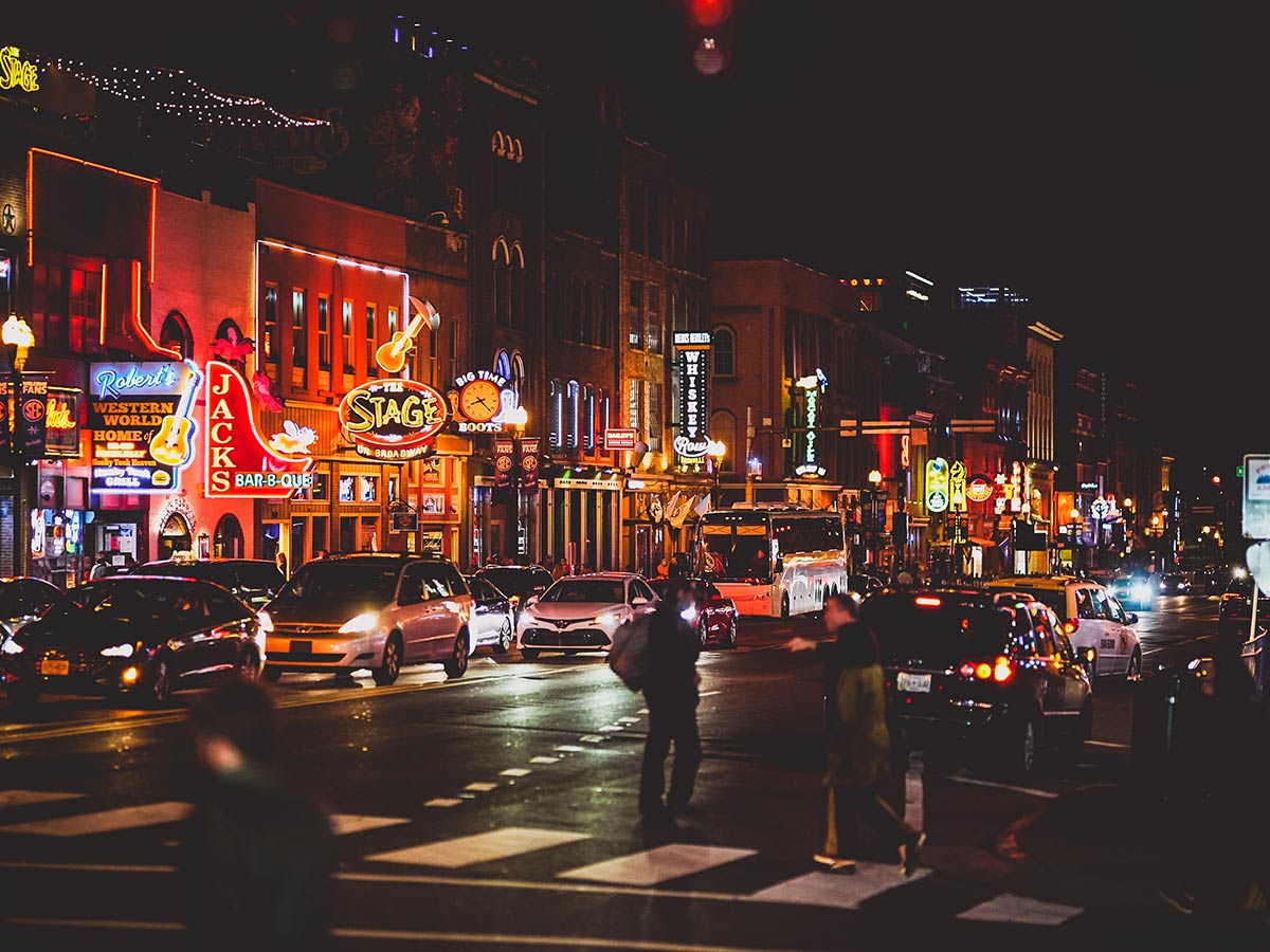 a night scene on broadway in nashville filled with people on the street