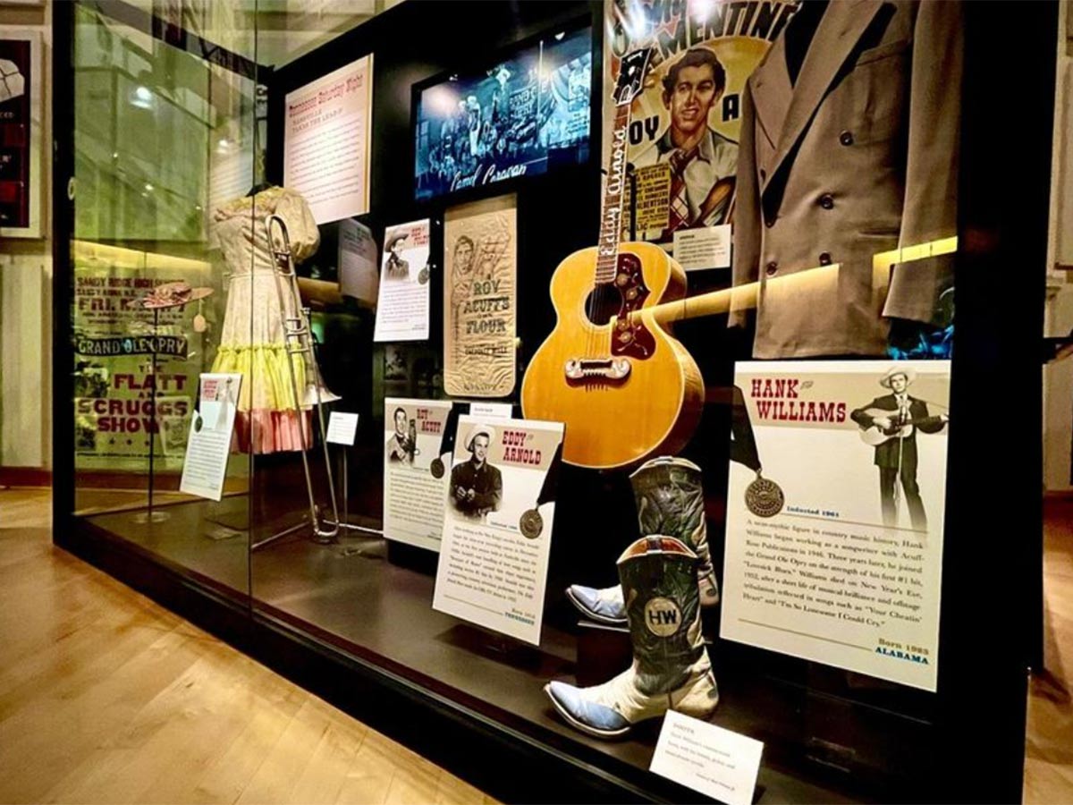 a exhibit of instruments and stage outfits at the country music hall of fame