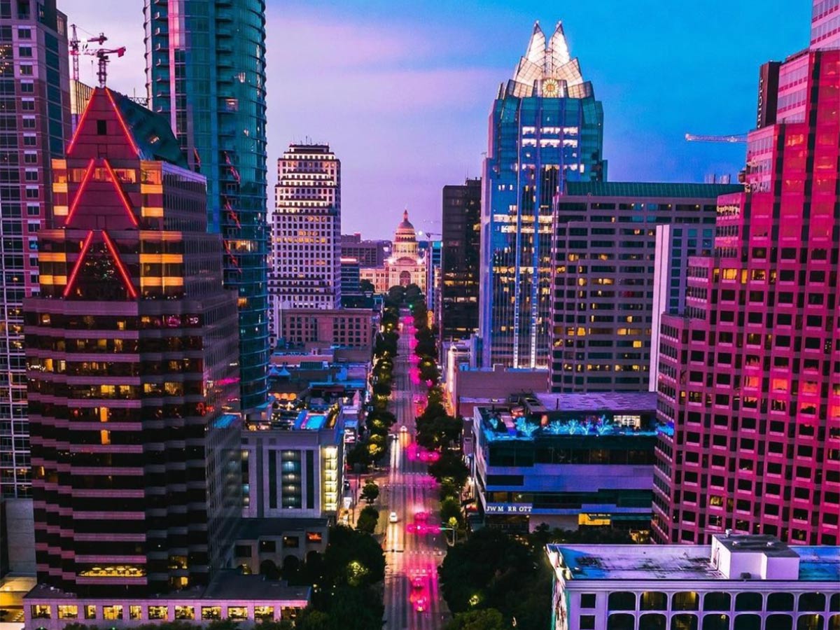 a view of downtown austin buildings lit in different colored lights