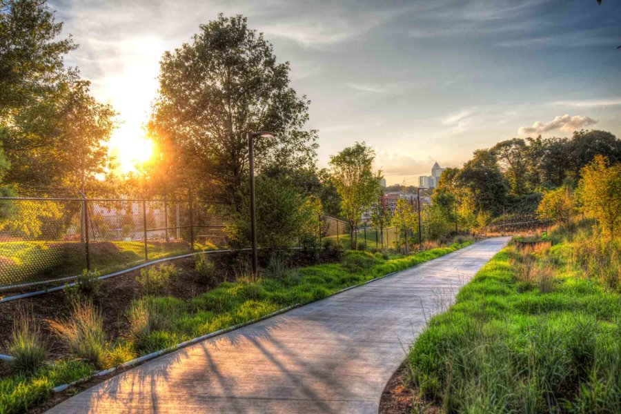 the atlanta beltline walk and bike path stretches into the sunset with greenery and trees on either side