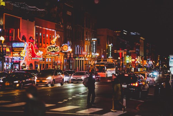 busy Broadway in Nashville with lights, bars, and people