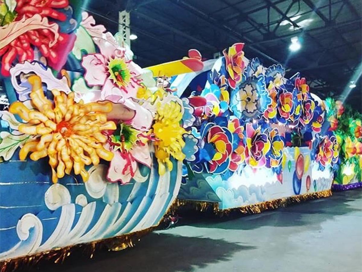 colorful mardi gras floats in a warehouse