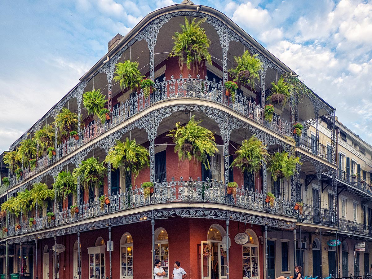 a picture of a building with balconies signifying the historic architecture of the french quarter in new orleans
