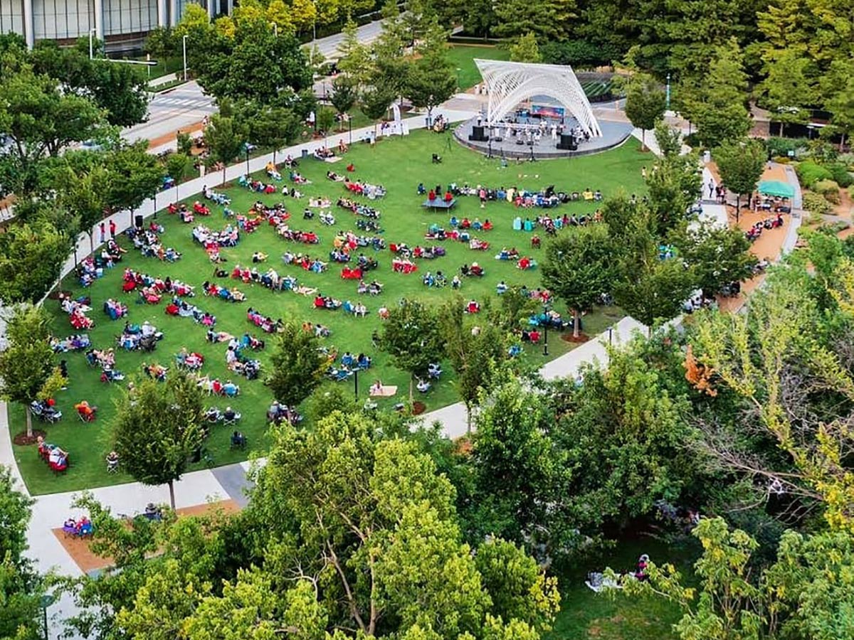 aerial view of people sitting on a lawn enjoying a concert at the myriad botanical gardens in oklahoma city