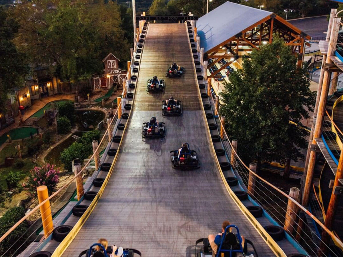 go kart riders drive over hills at the branson track