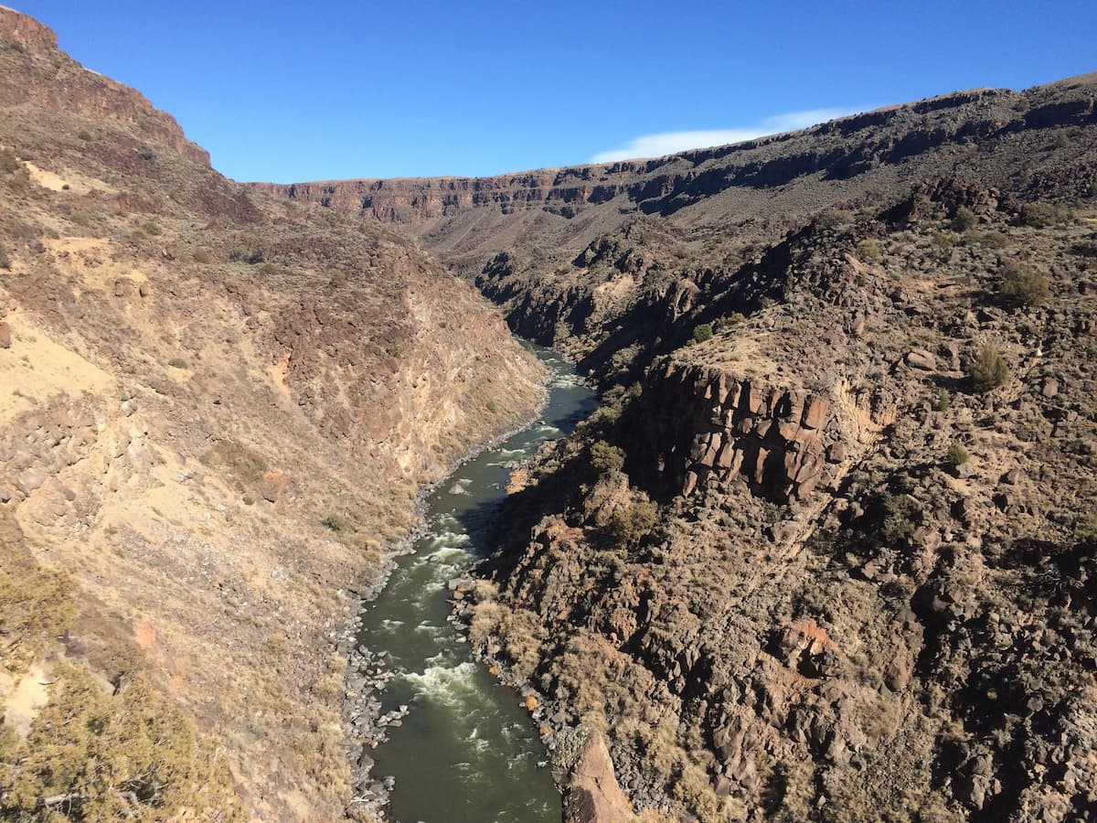 a river cuts its way through vista verde canyons