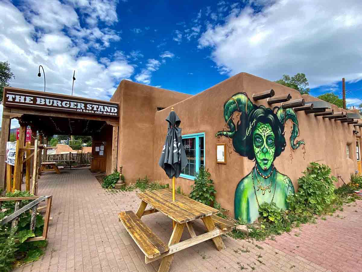 a mural on the side of the burger stand at taos ale house