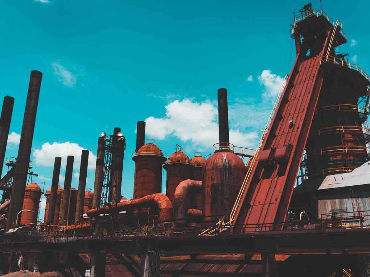 a view of the red smokestacks of sloss furnaces against the blue sky