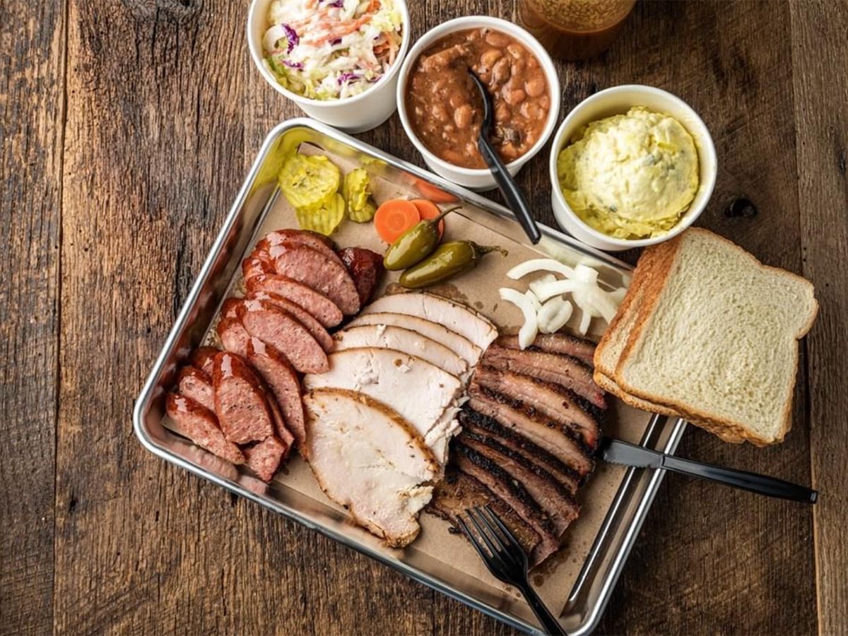 a plate of bbq meats and sides in san antonio