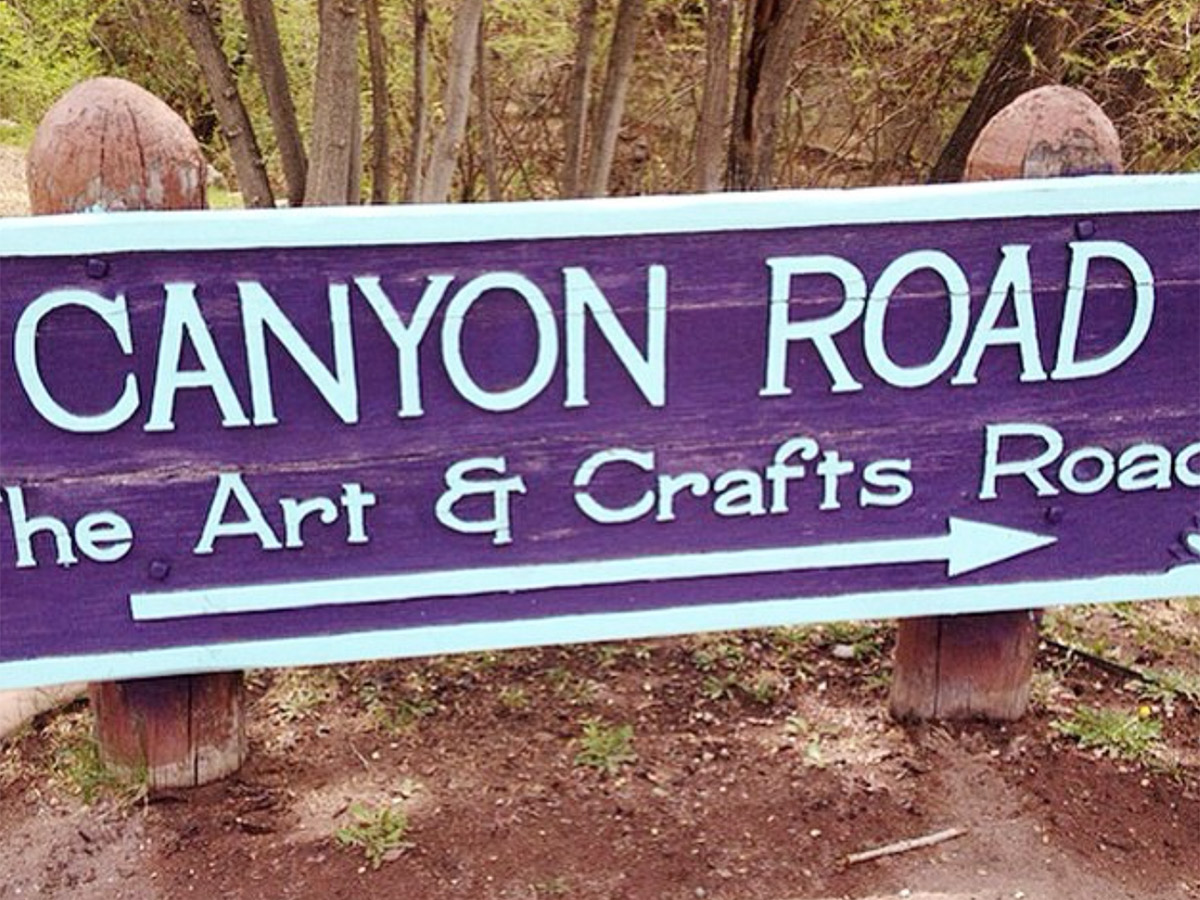 a sign showing the way to canyon road in santa fe