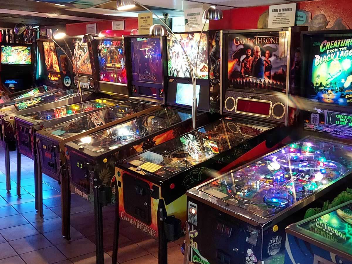 a row of pinball machines at the asheville pinball museum