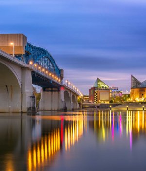 the historic chief john ross bridge in chattanooga over the tennessee river and downtown at night