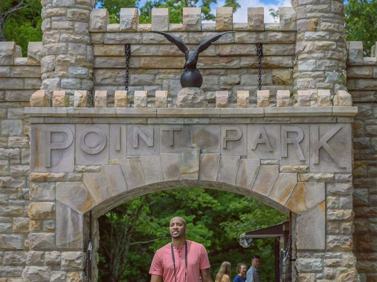 a visitor exits the large stone gates of point park in chattanooga