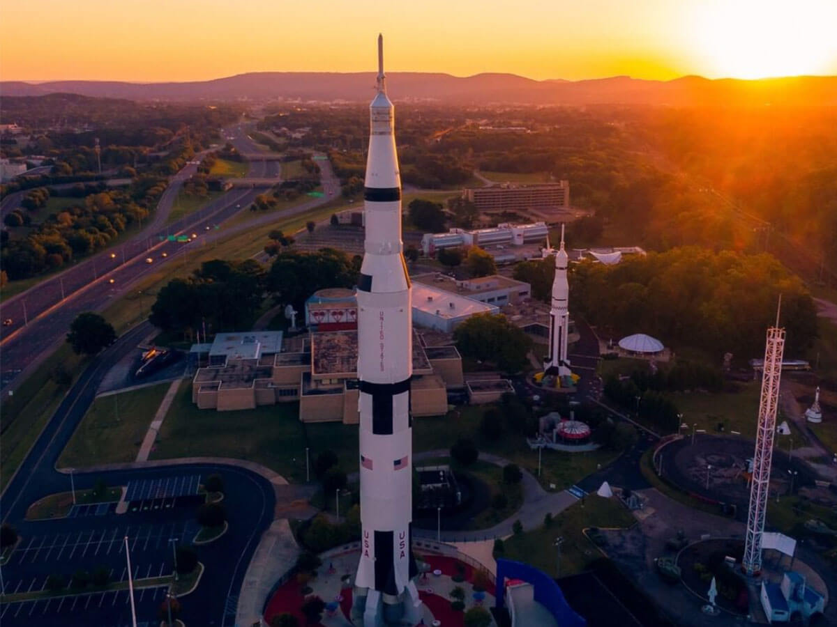 a sunset behind a rocket model at the u.s. space and rocker center in huntsville alabama