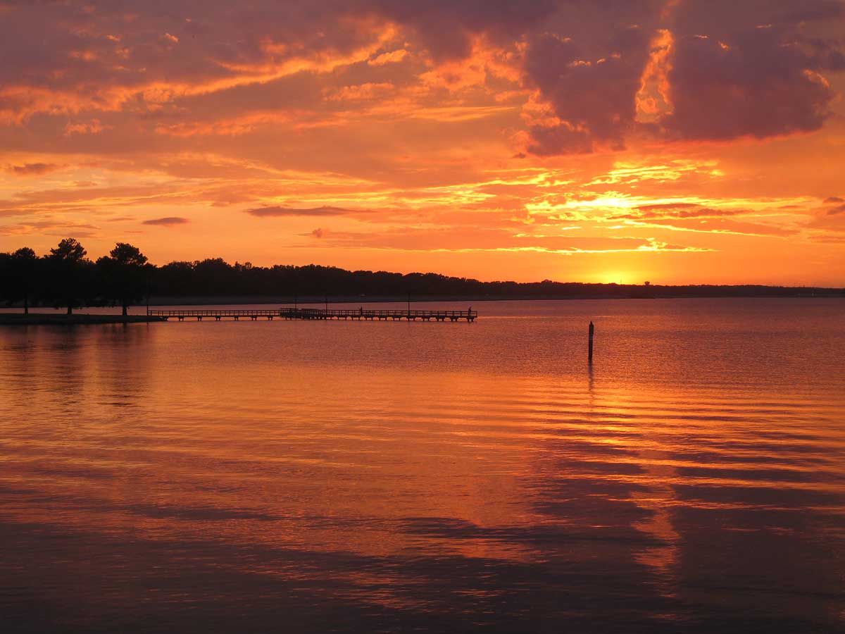 a orange sunset on the ross barnett reservoir north of jackson mississippi