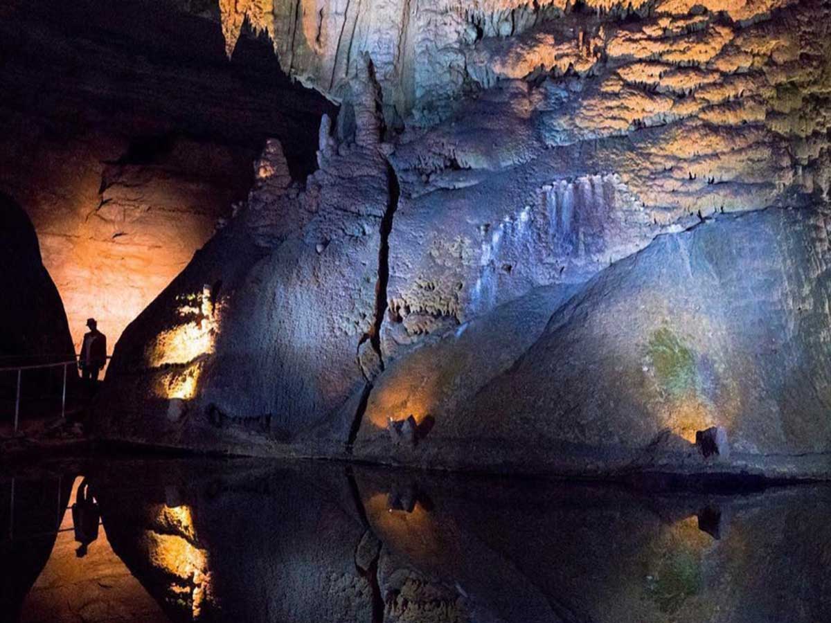 a rock formation at cathedral caverns state park in alabama lit up in lights