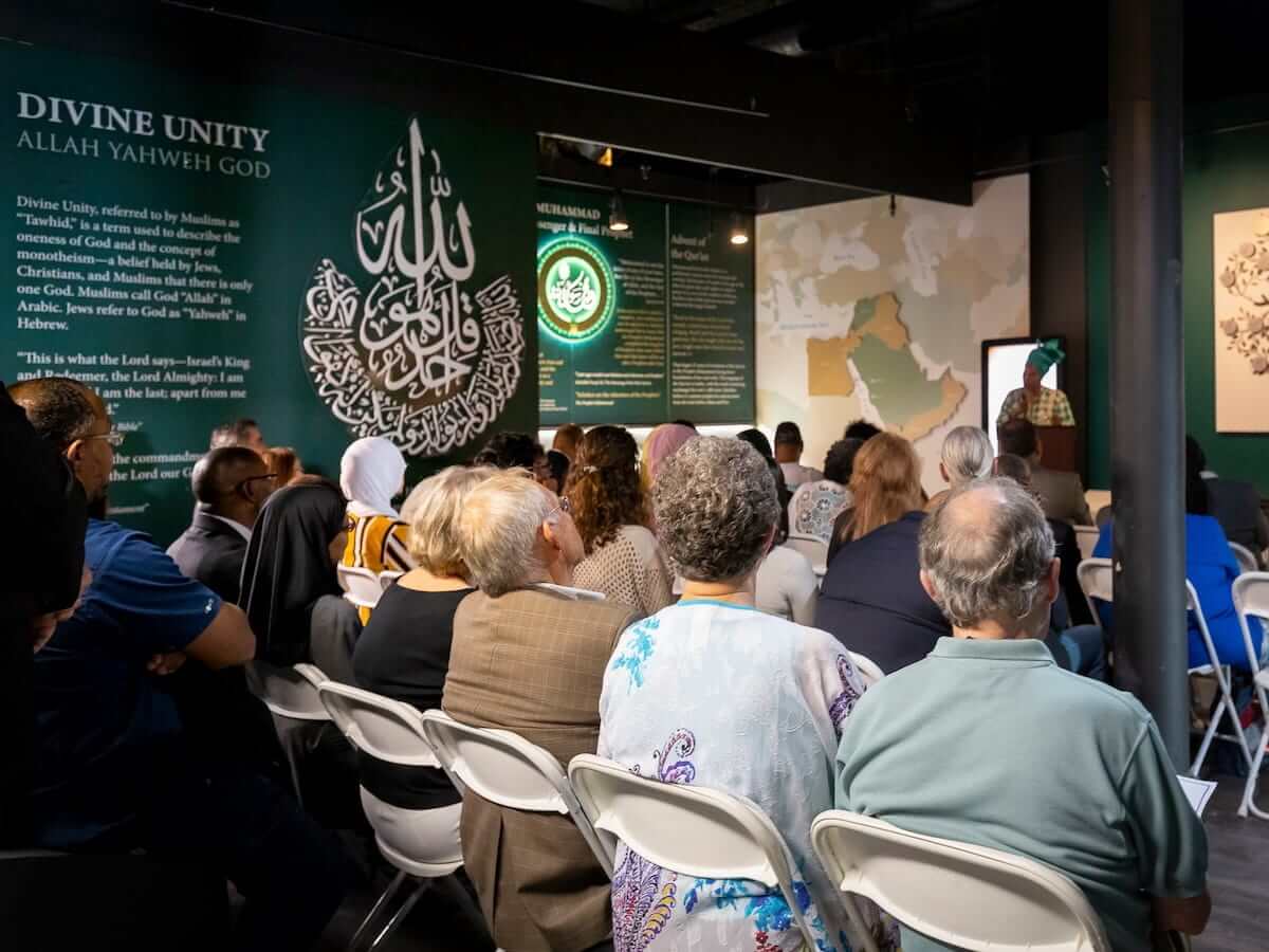 a woman giving a presentation at the internal museum of muslim cultures in jackson mississippi