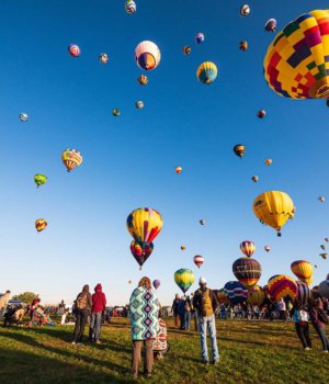 a sky filled with hot air balloons at a hot air balloon festival in new mexico