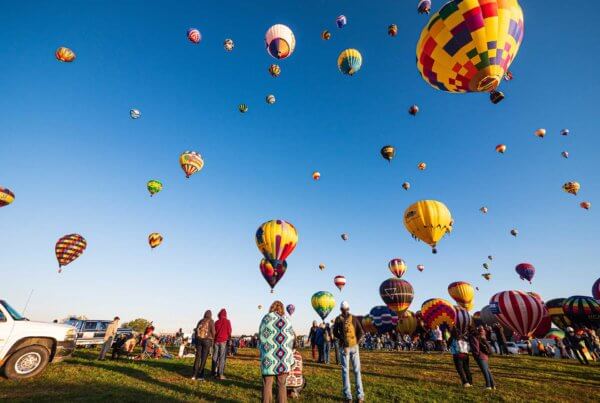 a sky filled with hot air balloons at a hot air balloon festival in new mexico