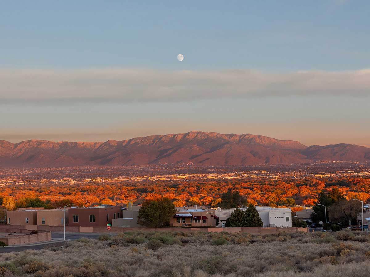 a landscape view of the sandia mountains near albuquerque at sunset