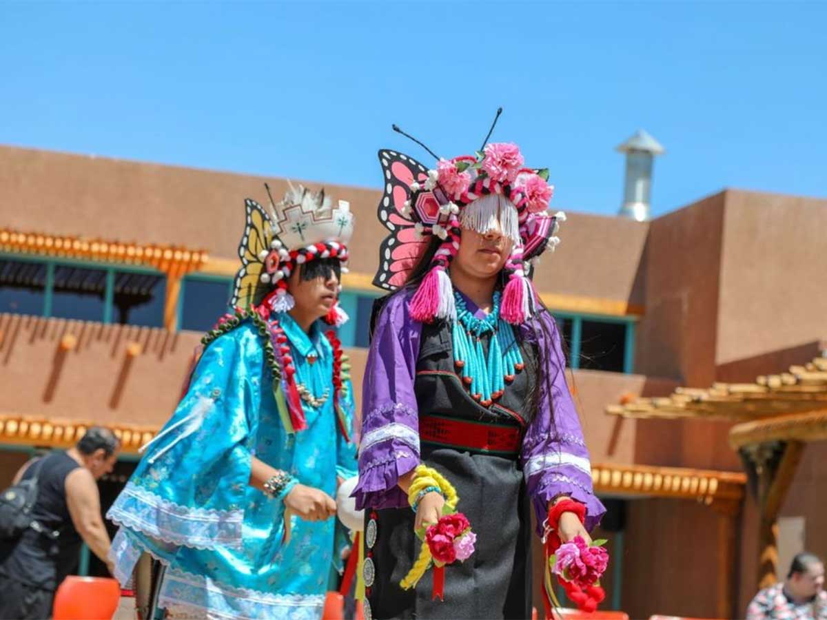 two individuals dressed in traditional outfits about to perform at the indian pueblo cultural center in albuquerque new mexico
