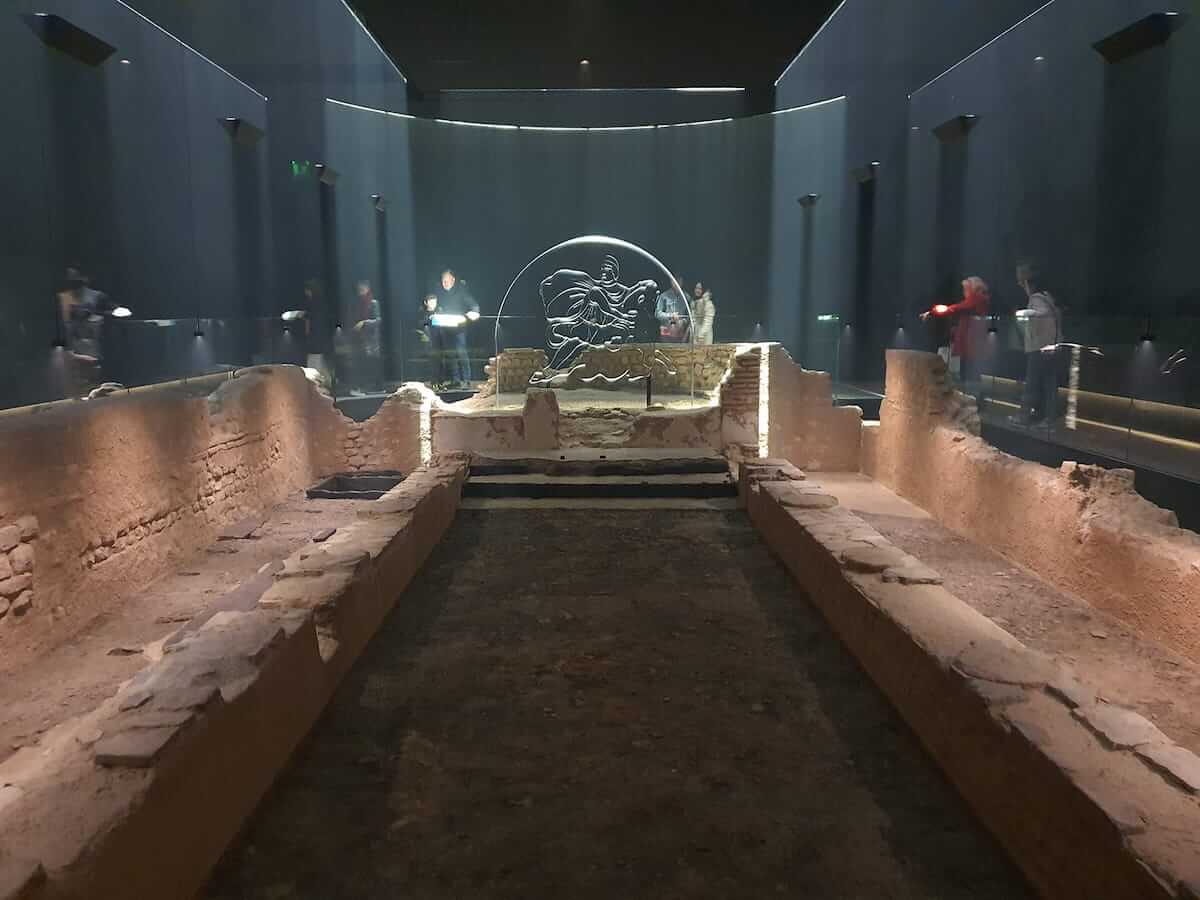 a view of the london mithraeum display area lit in low light