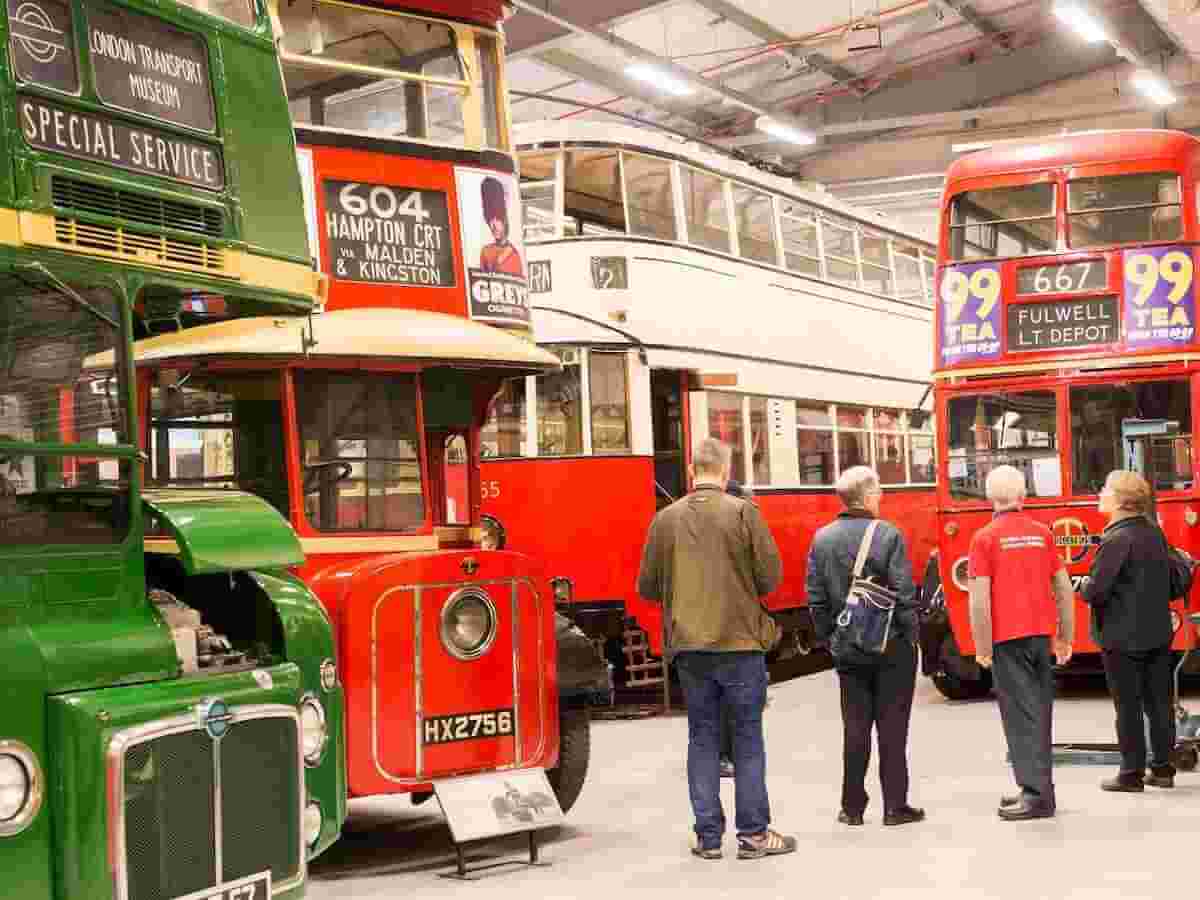 visitors tour the buses at the london transport museum