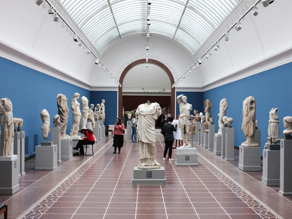 a gallery at the british museum filled with ancient greek statues
