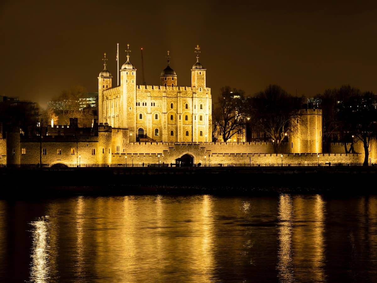 a view across the river at the tower of london lit up at night