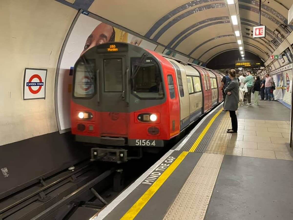 a train departs the camden town tube station in london