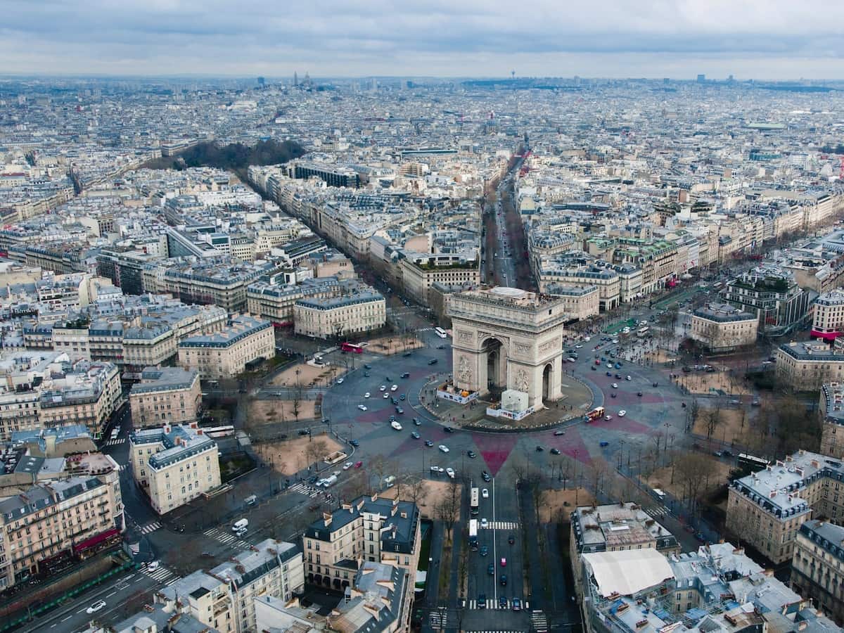 a aerial view of the arc de triomphe surrounded by the city of paris