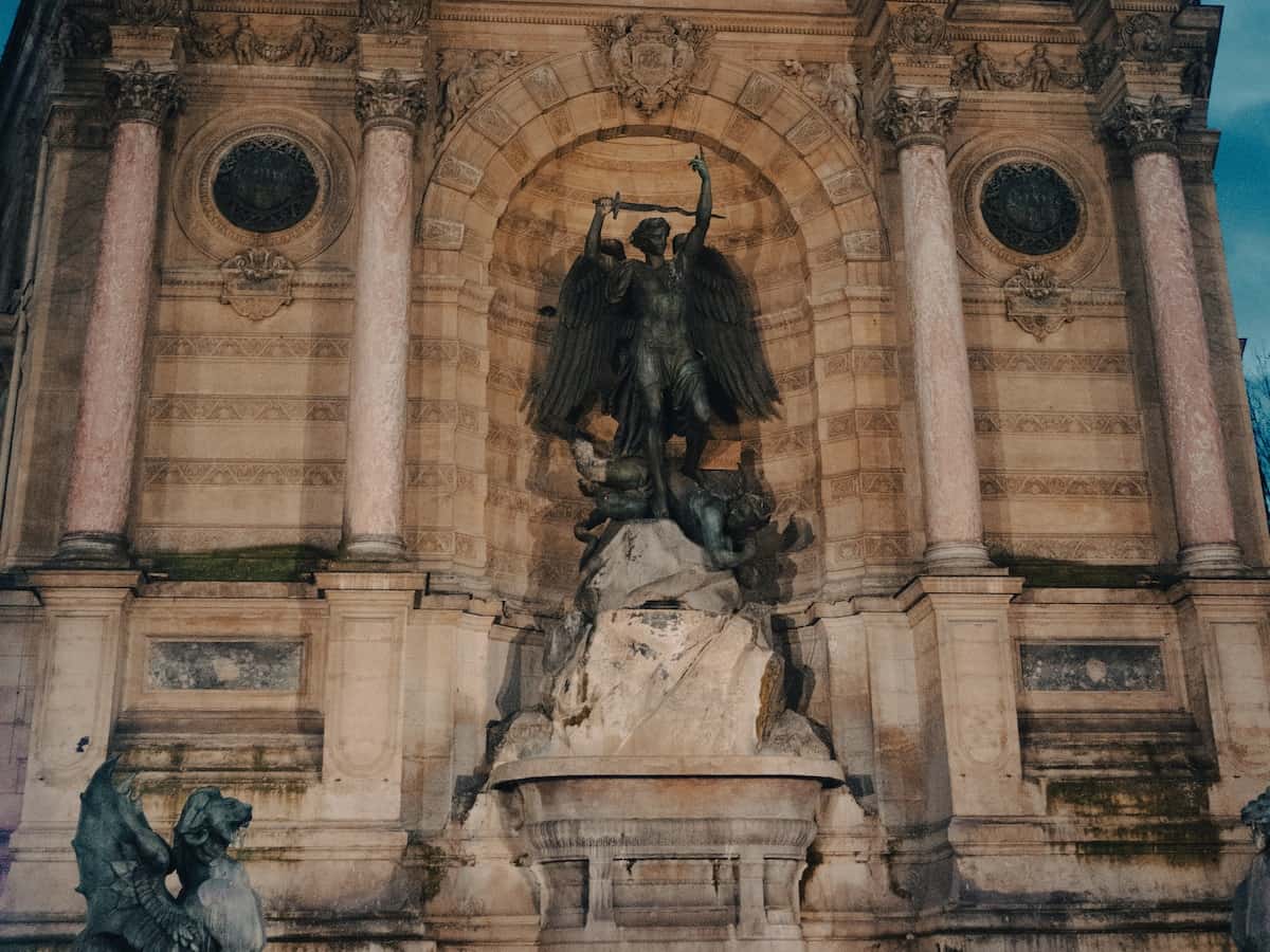 an ornate fountain in the place saint-michel located in the latin quarter of paris
