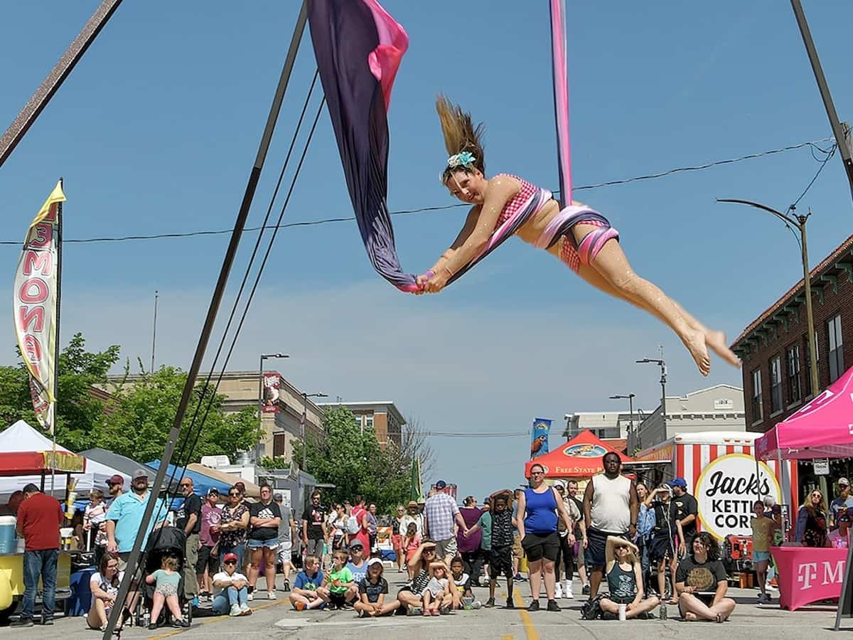a performer does circus arts on the street at the international busker festival