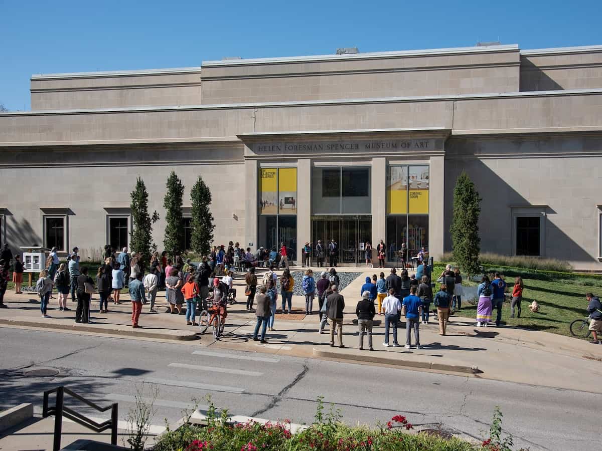 people gathered outside the exterior of the spencer museum of art in lawrence