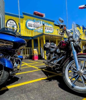 the front of the big texan restaurant in amarillo with motorcycles out front